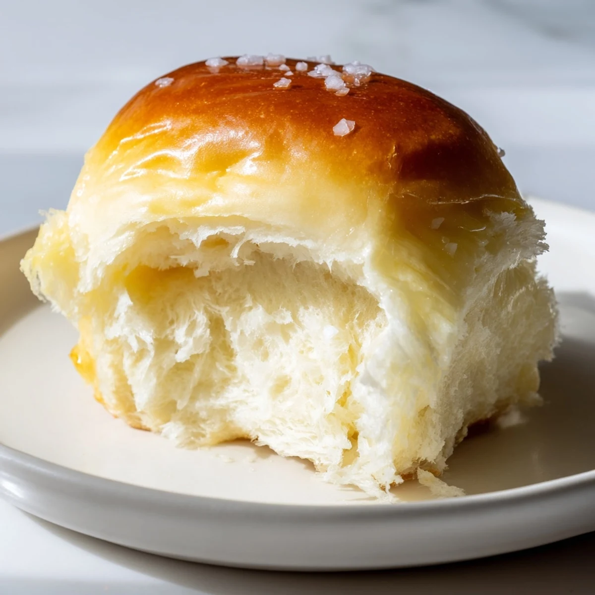 Golden-topped quick-rise dinner rolls, fresh from the oven, ready to serve with melting butter.