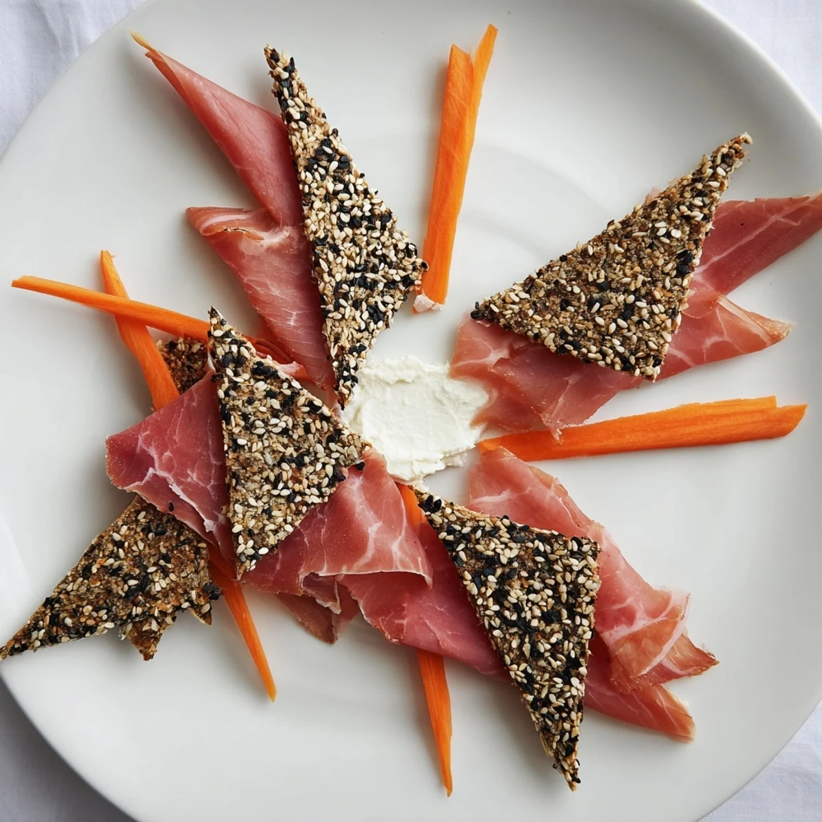 Delicate Paper Crane appetizer: folded prosciutto wings, creamy details, and crisp crackers ready to eat.