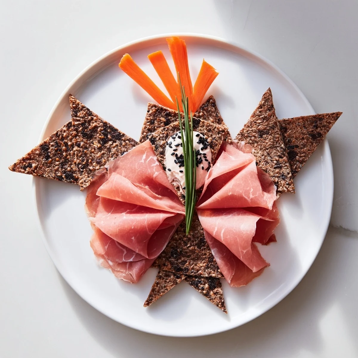 Beautiful arrangement of a Paper Crane: this appetizer features colorful carrot garnishes and textured crackers.