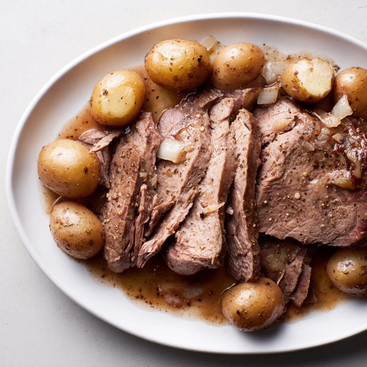 Fork-tender 4-ingredient slow cooker pot roast, falling apart with flavor and minimal prep time needed.