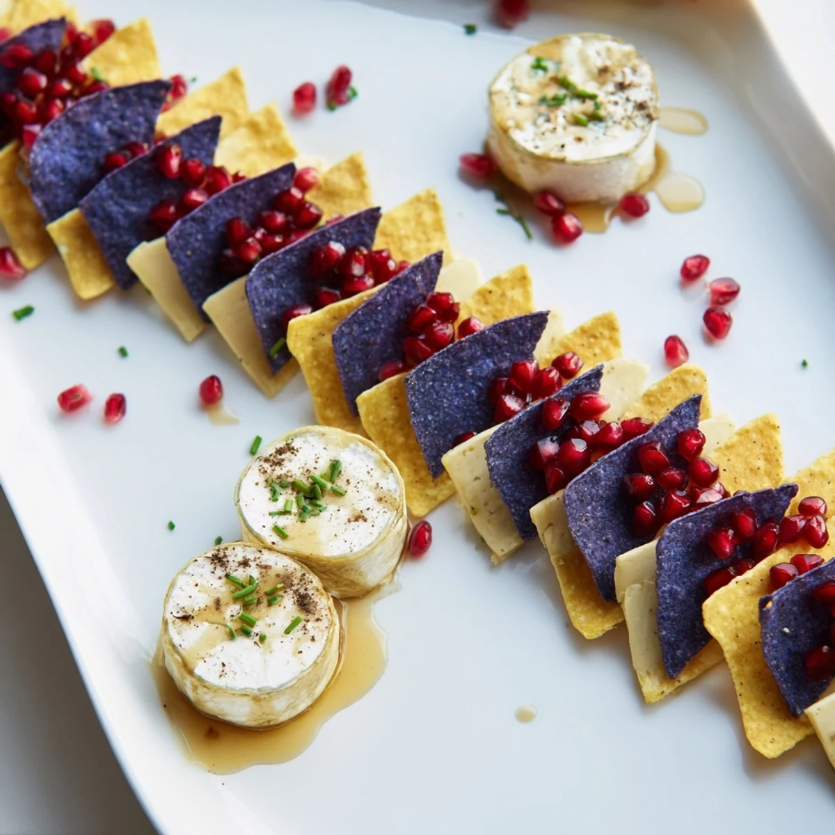 Cheese-ladened The Stepping Stones appetizer, featuring cheese stones atop a blue chip "river" garnished.
