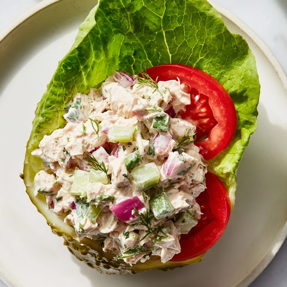 Crisp pickle sandwich with chicken salad, a refreshing low-carb main dish, ready to eat.