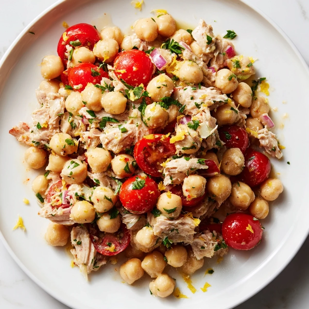 Creamy Dense Chickpea and Tuna Salad, bursting with fresh parsley and juicy cherry tomatoes.