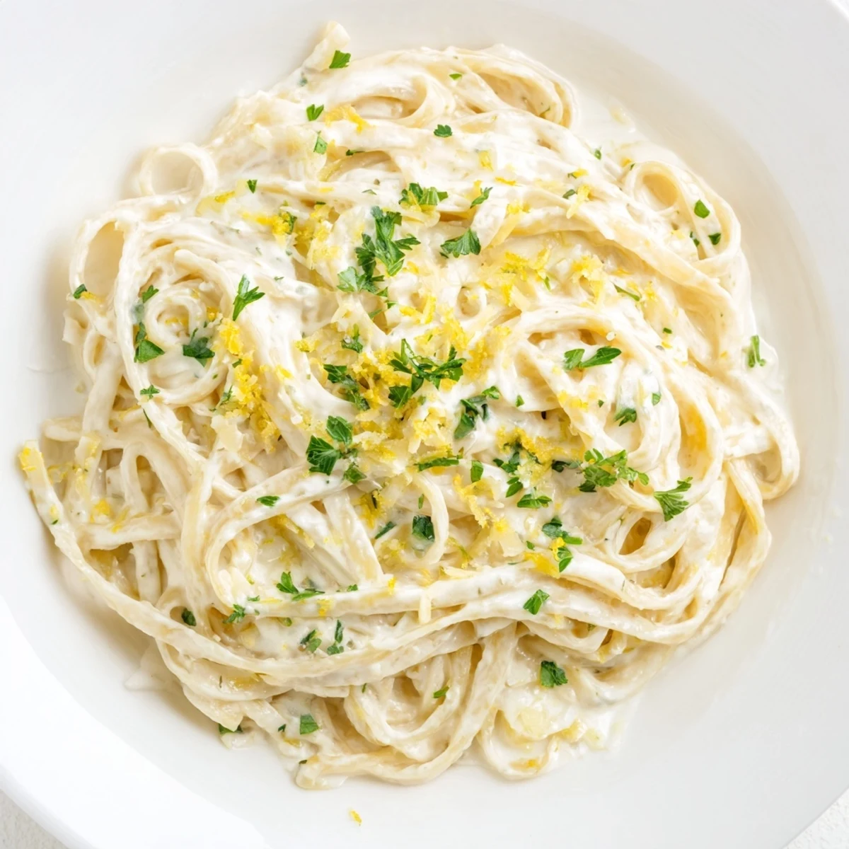 Lemon-Garlic Greek Yogurt Pasta, creamy and bright, is tossed with lemon zest and parsley.