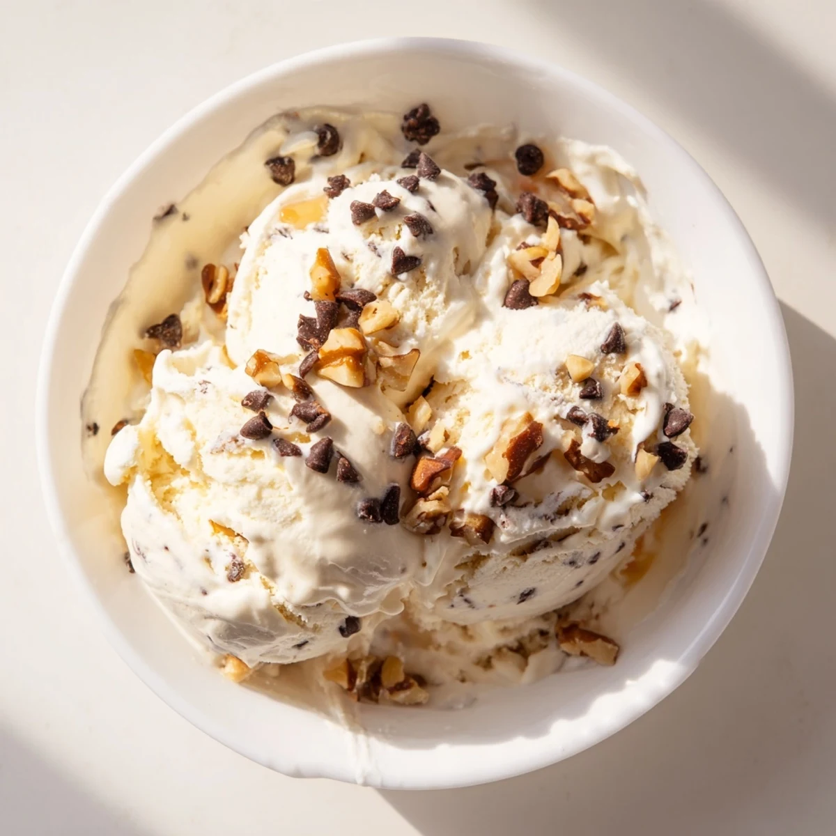 A close-up of a bowl of cottage cheese ice cream, ready to scoop and enjoy.