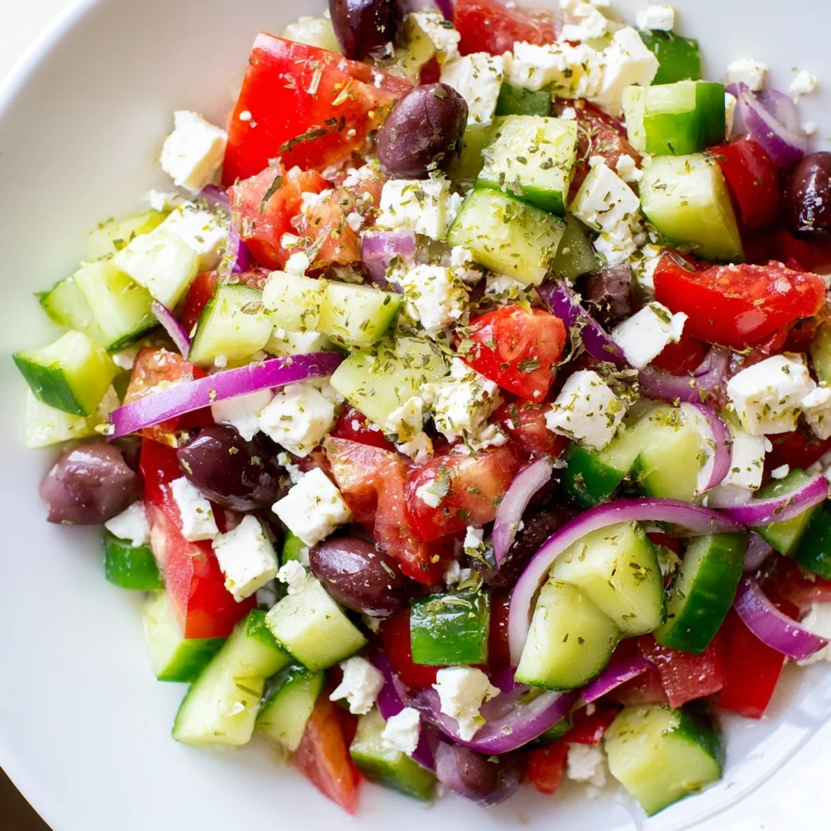 Vibrant Mediterranean salad bursting with color, featuring juicy tomatoes and creamy feta cheese.