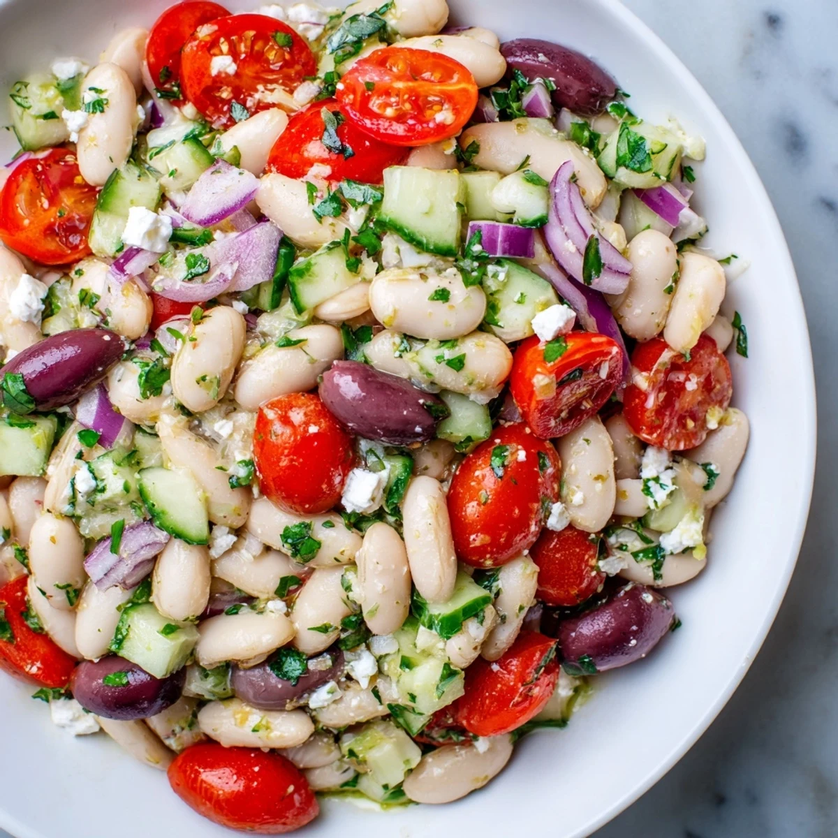 A bowl of delicious white bean salad, ready for a light lunch, with fresh basil visible.