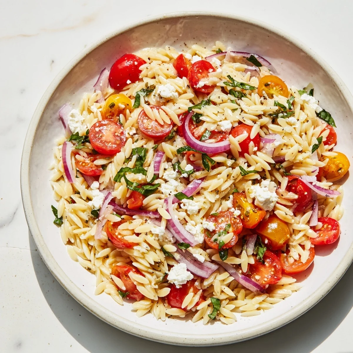 Tender orzo pasta tossed with tomatoes and feta, this vibrant Tomato Feta Orzo is a delicious side.