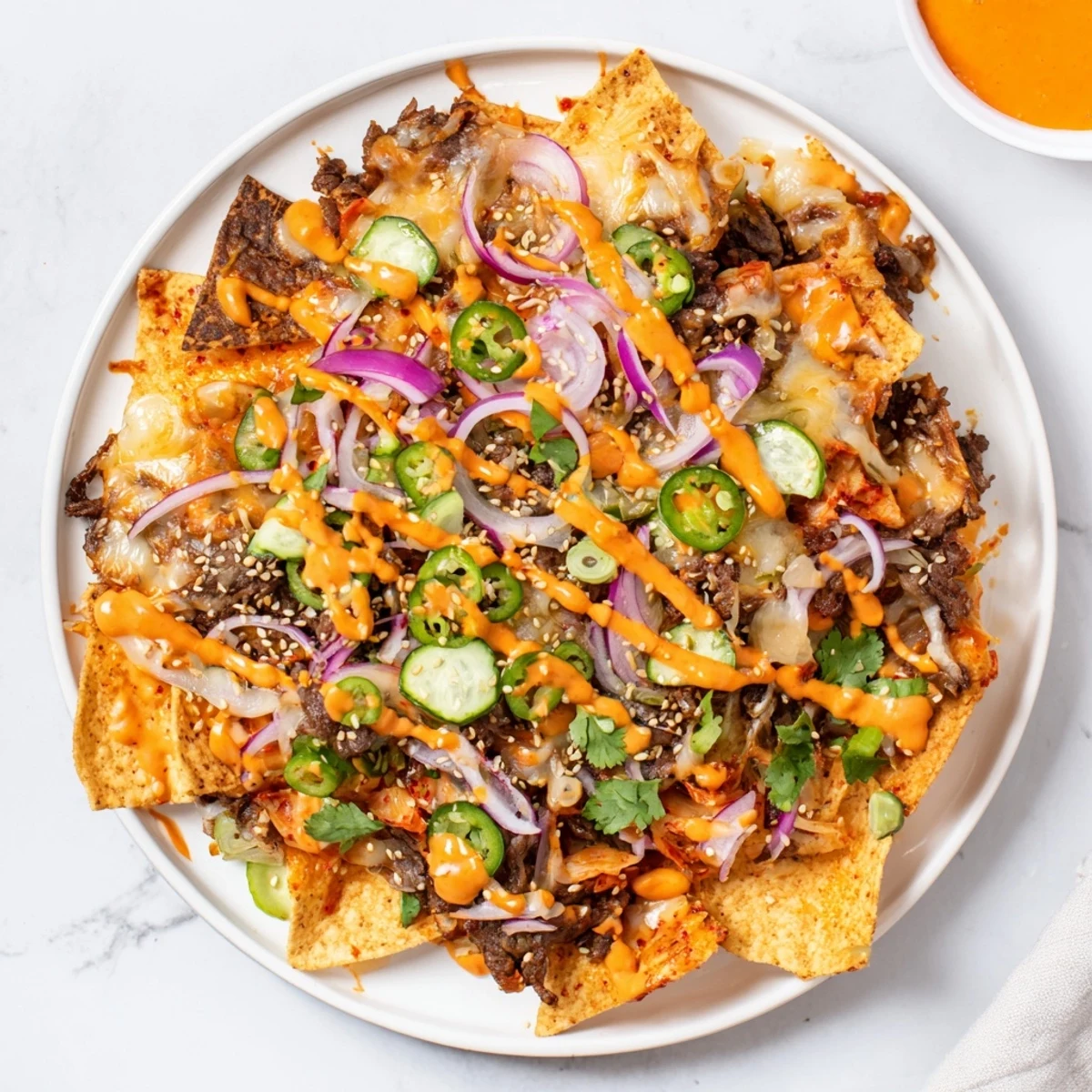Golden, bubbly Korean BBQ Nachos, ready to eat with layers of flavorful beef and fresh cilantro.