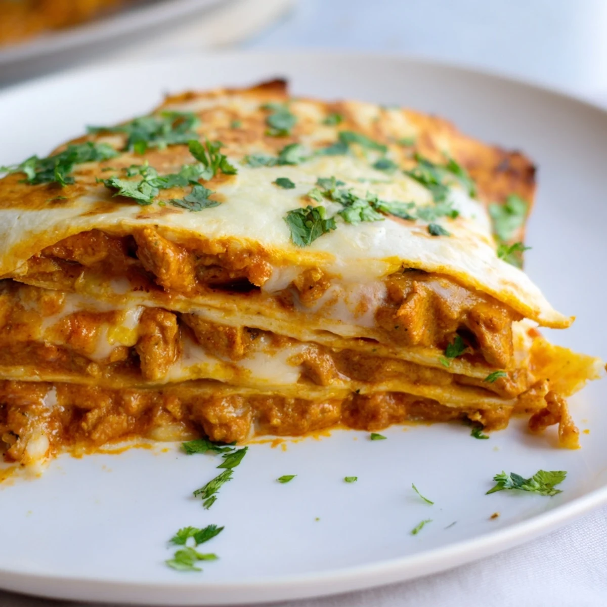 Melted cheese spills over golden butter chicken quesadillas, a delightful fusion food experience, ready to serve.