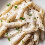Topped with fresh parsley and extra grated Parmesan, the Creamy Milk Pasta One-Pot showcases a luscious, velvety texture perfect for easy weeknight meals.  