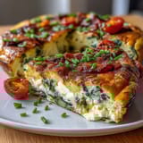 Fluffy spring veggie frittata with asparagus, goat cheese, and fresh herbs, baked until golden and set.