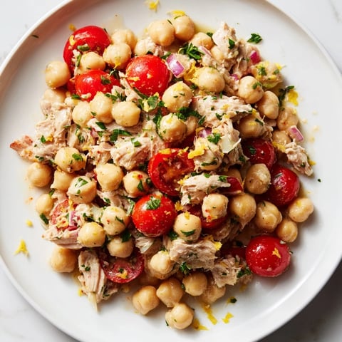 Creamy Dense Chickpea and Tuna Salad, bursting with fresh parsley and juicy cherry tomatoes.