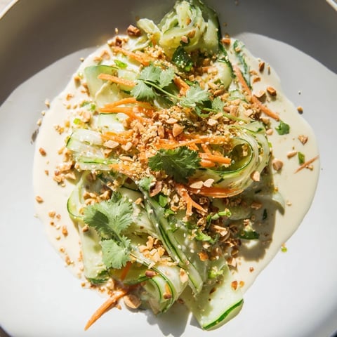 Vibrant Thai-Style Peanut Cucumber Salad, with crunchy cucumbers and creamy peanut dressing, ready to eat.