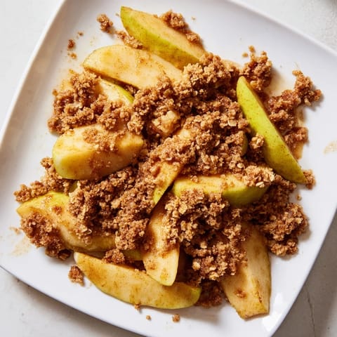A close-up of a delicious Rustic Apple and Cinnamon Crumb Bake, perfect with vanilla ice cream.