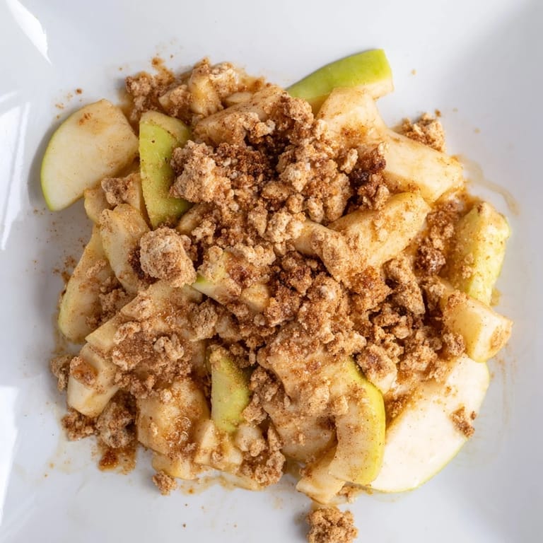 Freshly baked Rustic Apple and Cinnamon Crumb Bake, showcasing a buttery crumb topping and tender apples.