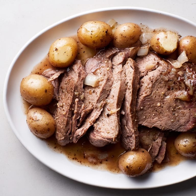 Fork-tender 4-ingredient slow cooker pot roast, falling apart with flavor and minimal prep time needed.