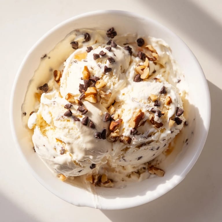A close-up of a bowl of cottage cheese ice cream, ready to scoop and enjoy.