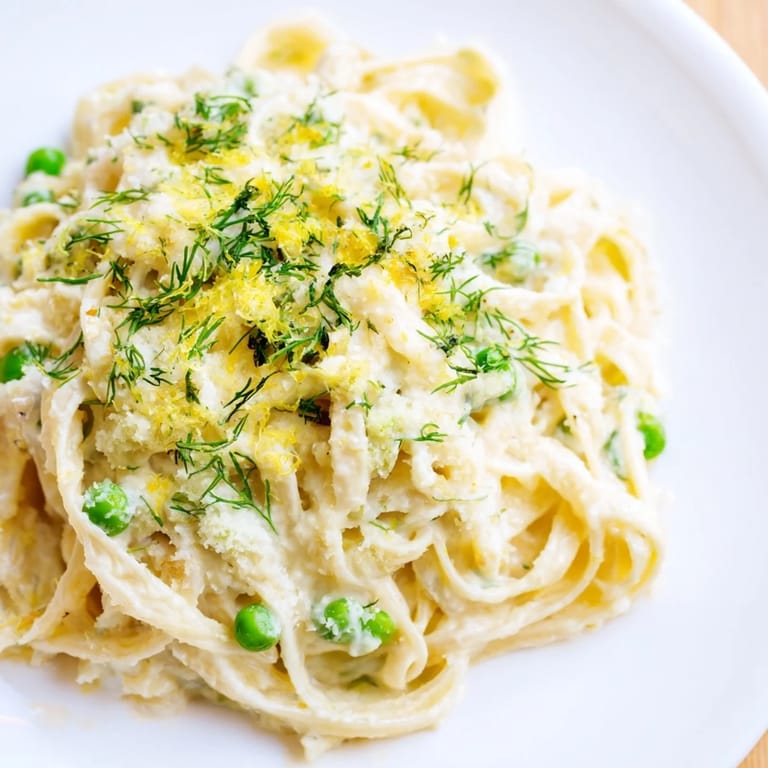 Fettuccine enrobed in a rich, creamy dill pasta sauce, a vegetarian delight.