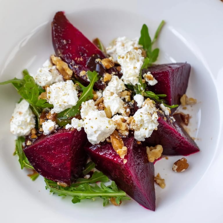 This vegetarian gluten-free roasted beet goat cheese salad features jewel-toned beets, peppery arugula, and crunchy walnuts tossed in a bright, honey-Dijon dressing.