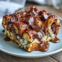 Decadent chocolate croissant bread pudding baked with rich custard and semisweet chocolate chips for a cozy brunch treat.  